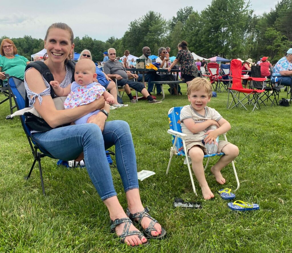 Mom with two kids sitting at park