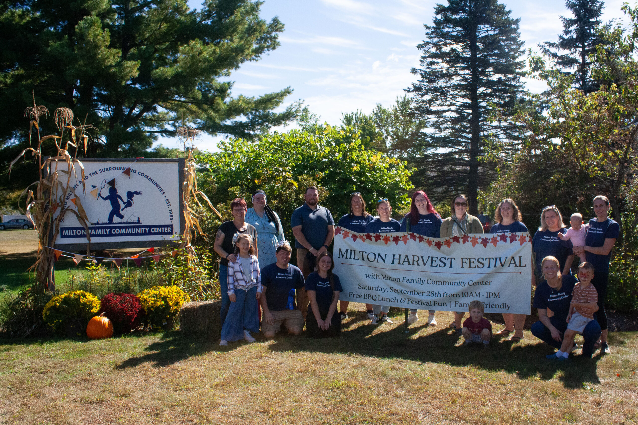 MFCC staff standing in front of Community Center sign