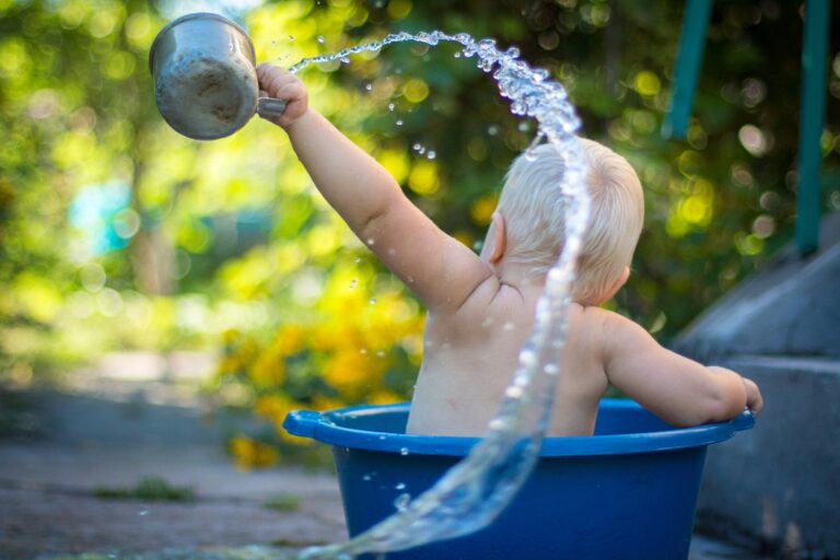 child throwing water into the air